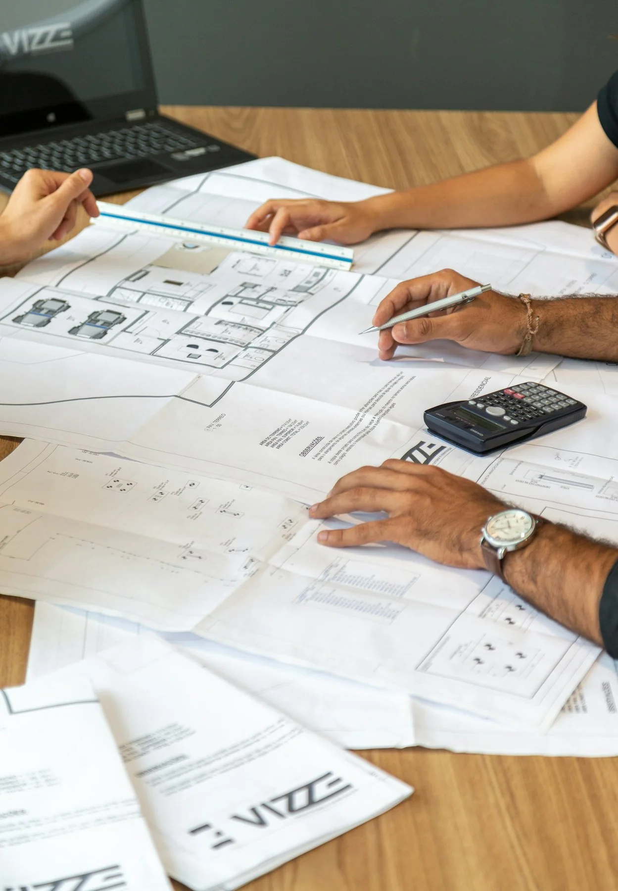 People reviewing architectural drawings